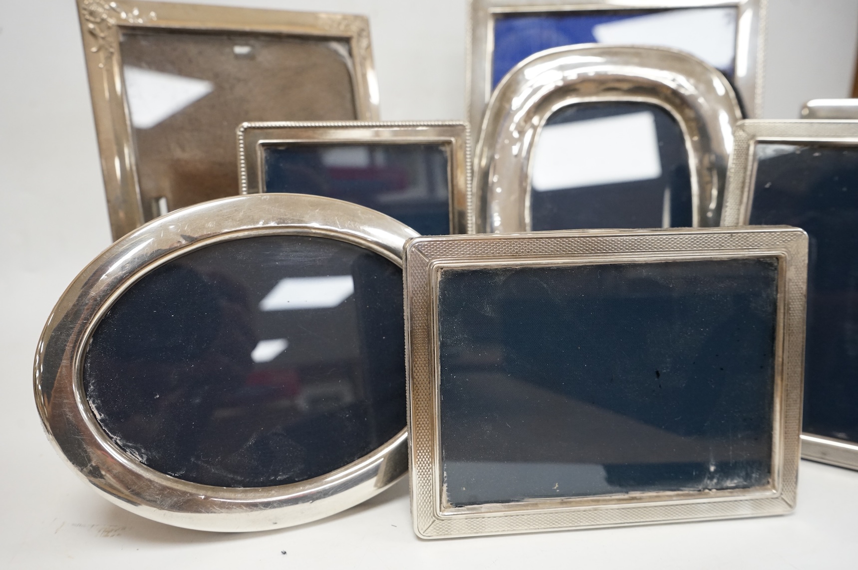 A pair of modern engine turned silver mounted rectangular photograph frames, by Carr's of Sheffield, Sheffield, 1992/3, 14.8cm, together with seven other modern silver mounted photograph frames, largest 23.1cm.